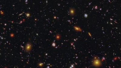 Hubble and JWST composite image showing the tiny early-universe galaxy MXDFz4.4, which cleared a bubble of neutral hydrogen during the Era of Reionization, 1.4 billion years after the Big Bang.