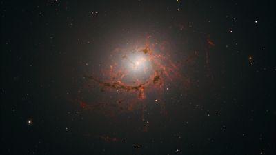 Hubble WFC3 image of NGC 4696, the largest galaxy in the Centaurus Cluster, showing dusty filaments spiralling around its central supermassive black hole.
