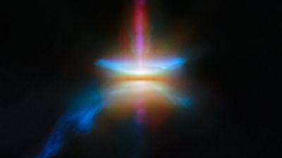 Webb infrared view of the edge-on protoplanetary disk HH 30, with a dark dust lane and jets of gas launched above and below the disk.