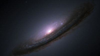 Type Ia supernova SN 1994D shines as a bright point of light at the edge of galaxy NGC 4526, imaged by the Hubble Space Telescope.