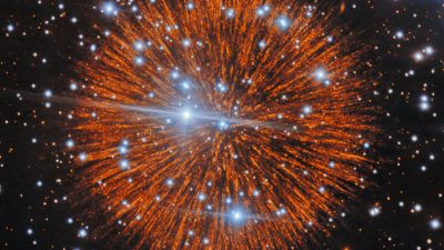 Supernova remnant Pa 30 imaged by the Gemini North telescope: an orange, firework-like sphere of radial filaments surrounding its hot blue central star.