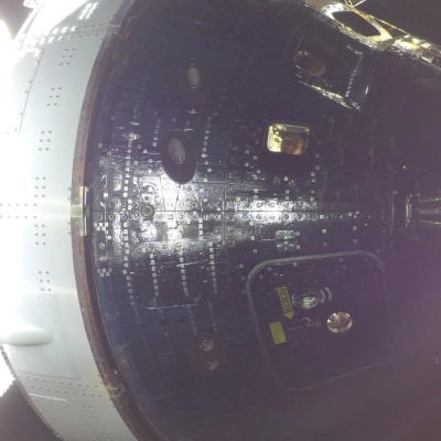 art002e009014 (April 4, 2026) - Artemis II Mission Specialist Christina Koch (center) and Commander Reid Wiseman (top) are seen through...