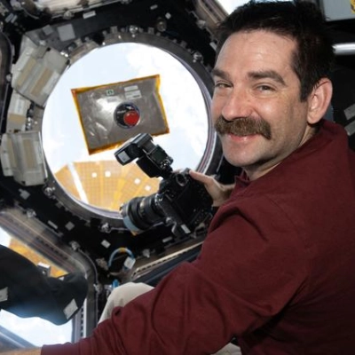 NASA astronaut Jack Hathaway smiles for a portrait inside the International Space Station’s cupola