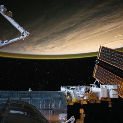 The International Space Station orbits above a cloudy Atlantic Ocean