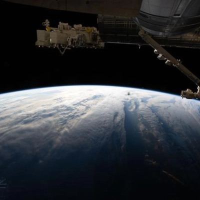 The International Space Station orbits above a cloudy Atlantic Ocean