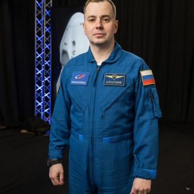 Roscosmos cosmonaut Oleg Platonov poses for a photo during an interview