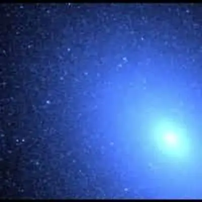 Hot Blue Stars Resemble a Blizzard of Snowflakes Near Core of Galaxy M32