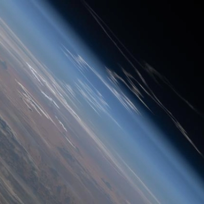 The exhaust plume left behind by Artemis II is pictured from the International Space Station