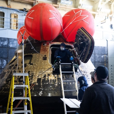 NASA’s Orion spacecraft is seen in the well deck of USS John P. Murtha as NASA teams begin to work...