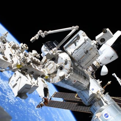 The forward portion of the International Space Station with Kibo and the SpaceX Dragon