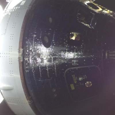 art002e009013 (April 4, 2026) - Artemis II Mission Specialist Christina Koch is seen through a window of the Orion spacecraft...