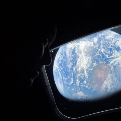 art002e008486 (April 4, 2026) - NASA astronaut and Artemis II Commander Reid Wiseman peers out of one of the Orion...