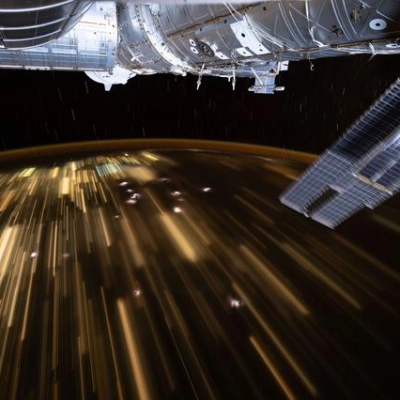 The warm city lights of Southeast Asia streak below the International Space Station