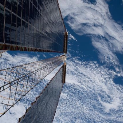 A view peering down a pair of the International Space Station's roll-out solar arrays
