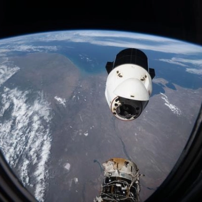 A SpaceX Dragon spacecraft backs away from the International Space Station
