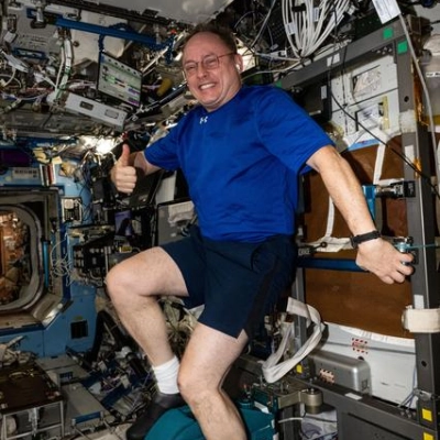 NASA astronaut pedals on the International Space Station's exercise cycle