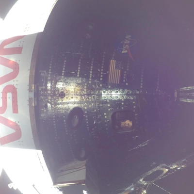 art002e009008 (April 4, 2026) - Artemis II Mission Specialist Jeremy Hansen is seen through a window of the Orion spacecraft...