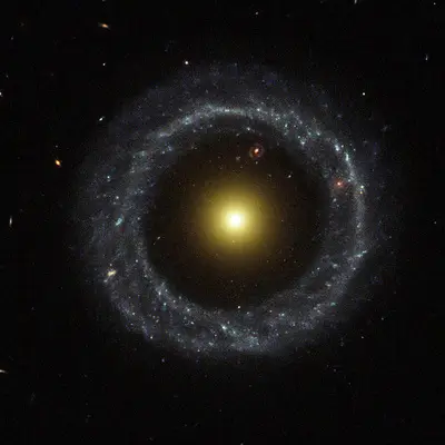 Ring of Hot Blue Stars Pinwheels Around Yellow Nucleus of Hoag's Object Galaxy