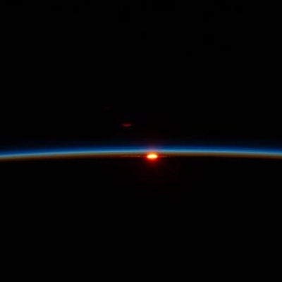 The first rays of an orbital sunrise illuminate Earth’s atmosphere