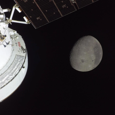 art002e009562 (April 6, 2026) - The Orion spacecraft is seen in the foreground lit up by the Sun. A waxing...