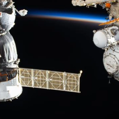The International Space Station orbits into a sunset above China