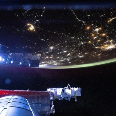 The International Space Station begins to shine brightly as it orbits into a sunrise