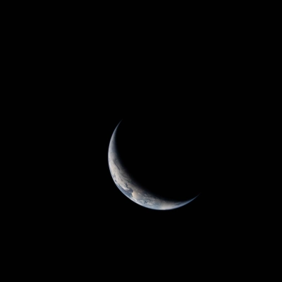 art002e004437 (April 3, 2026) - A sliver of Earth is illuminated against the blackness of space in this photo taken...