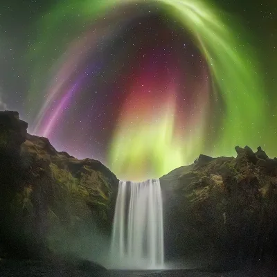 Colorful Aurora over Icelandic Waterfall
