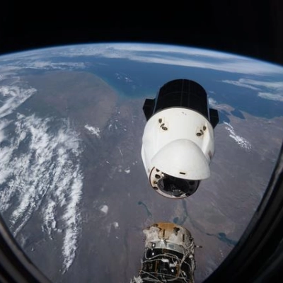 A SpaceX Dragon spacecraft backs away from the International Space Station