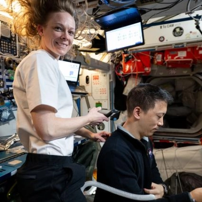 Nichole Ayers trims Jonny Kim's hair aboard the International Space Station