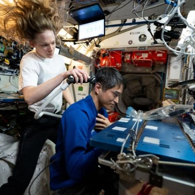 Nichole Ayers trims Takuya Onishi's hair aboard the International Space Station