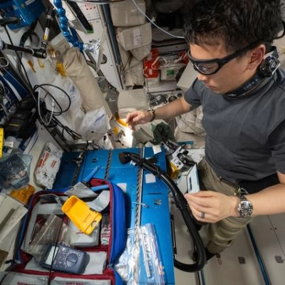 NASA astronaut Jonny Kim repairs ethernet cables aboard the International Space Station