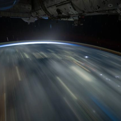The city lights of Southeast Asia and lightning storms streak below the International Space Station