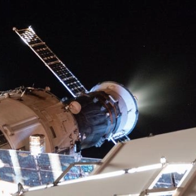 The Progress 93 cargo craft fires its engines to raise the International Space Station's orbit