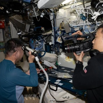 Astronaut Kimiya Yui trims his own hair aboard the International Space Station