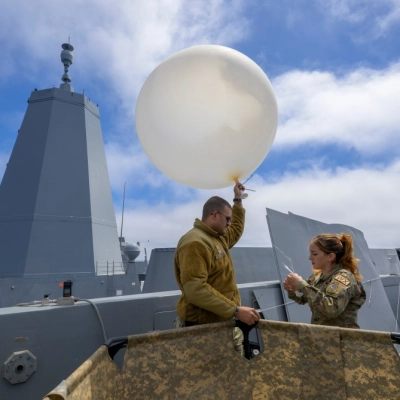 Airmen of the 45th Weather Squadron prepare a weather balloon for launch as NASA, U.S. Navy, and U.S. Air Force...