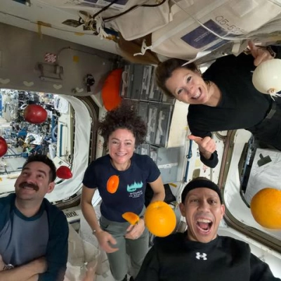 Expedition 74 flight engineers celebrate a shipment of fresh food aboard the International Space Station