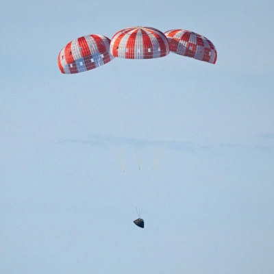 Parachutes secured to NASA’s Orion spacecraft deploy before splashdown in the Pacific Ocean near San Diego, California, on Friday, April...