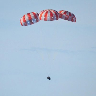 Parachutes secured to NASA’s Orion spacecraft deploy before splashdown in the Pacific Ocean near San Diego, California, on Friday, April...